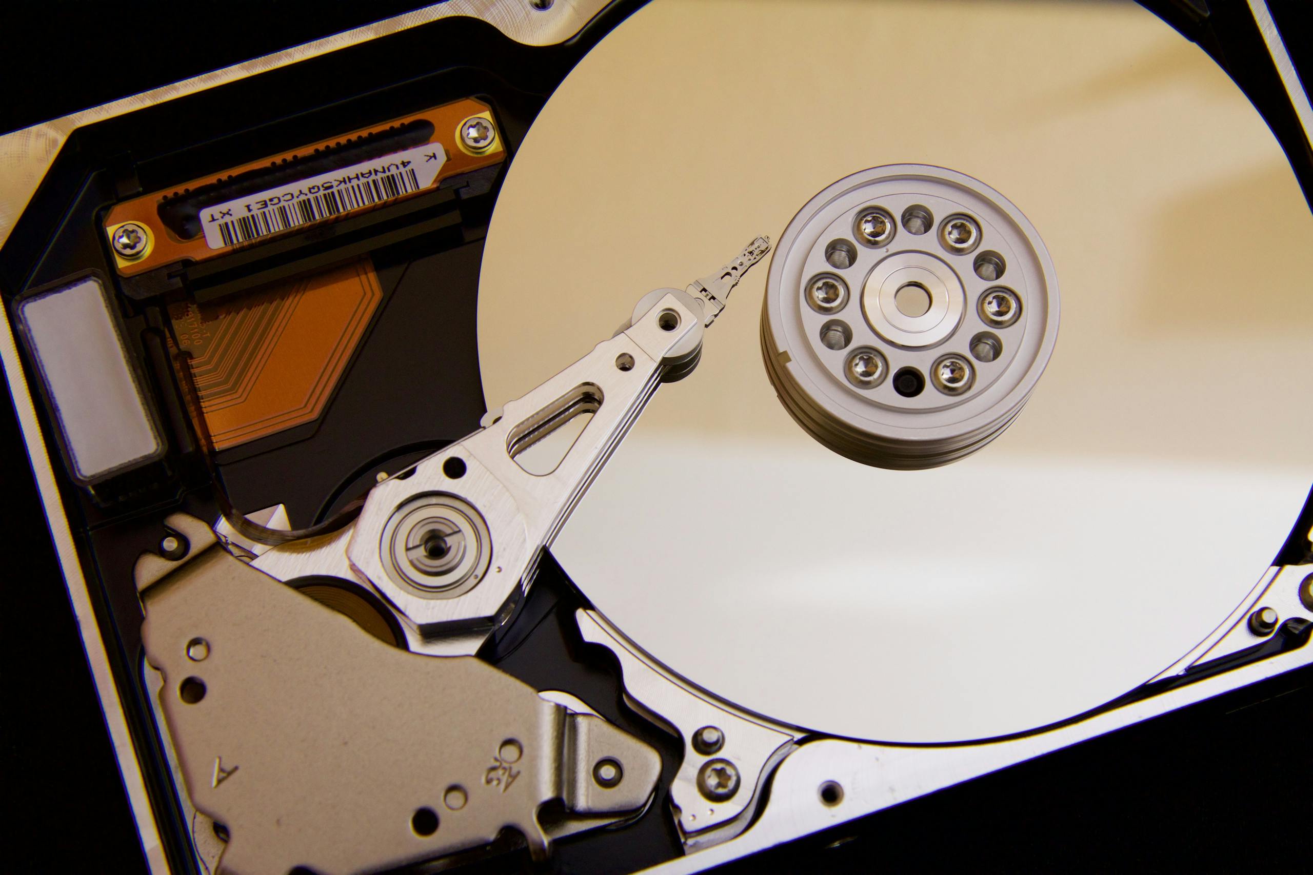 Detailed close-up of a hard disk drive showing the actuator arm and data platters.